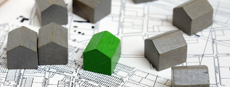 Models of houses Small models of houses are on a building plan.