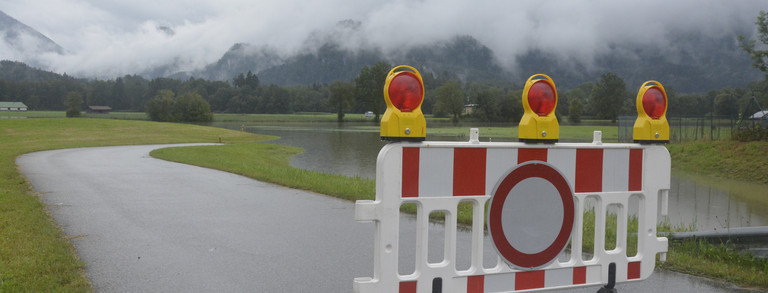 Schleching Summer 2020 Photo of a flooded road in rural areas with a road sign for motorists.