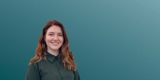Cornelia Roboger in front of a blue background.